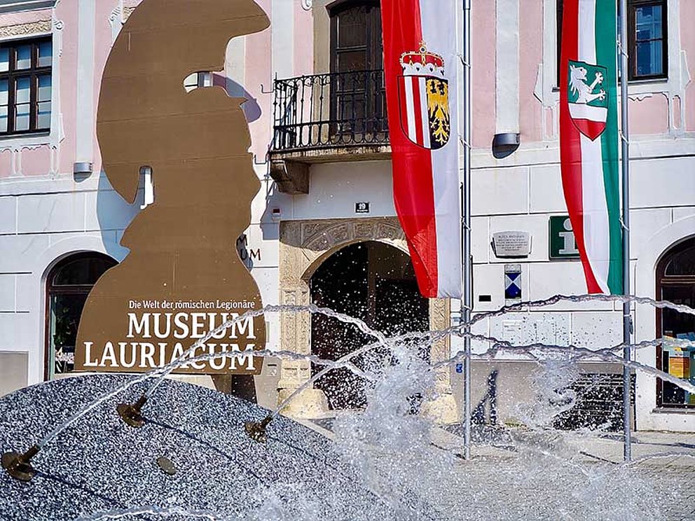 Außenansich Museum Lauriacum in Enns mit Springbrunnen und OÖ Flagge