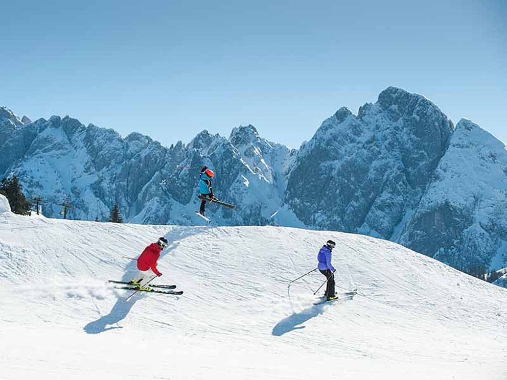 Skifahrer und Skisprung in der Skiregion Dachstein West